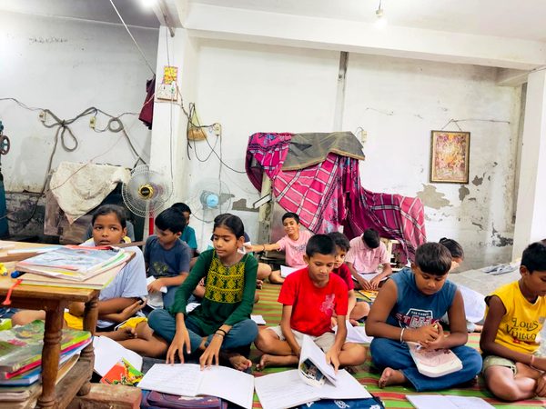 Group learning session with children reading and writing